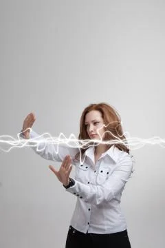 Woman making magic effect - flash lightning. The concept of electricity, high Stock Photos
