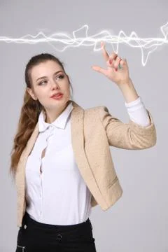 Woman making magic effect - flash lightning. The concept of electricity, high Stock Photos