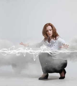 Woman making magic effect - flash lightning. The concept of electricity, high Stock Photos