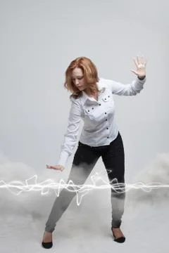 Woman making magic effect - flash lightning. The concept of electricity, high Stock Photos