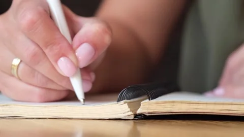Woman making notes in diary. Ideas and plans concept, wish list concept. Video stock 252447412