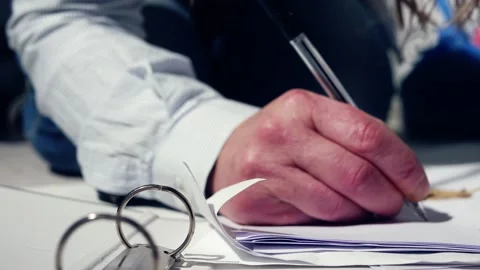 Woman making notes in a folder medium shot Stock Footage 234215924