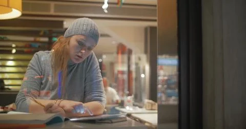 Woman Making Notes in Notebook Stock Photos