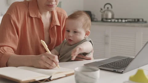 Woman Making Notes in Notebook while Babysitting Video stock 306654361