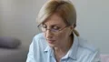 Woman making notes in notepad carefully hearing online classes, self-development HD Footage