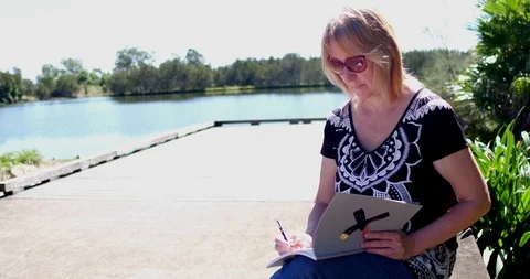 Woman making notes in park Stock Footage 88646956