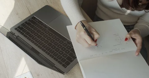 Woman making notes reading email letter on laptop screen sitting at cafe table. Stock Footage 127284496