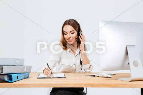 Woman making notes while talking with custumer on the phone Stock Photos