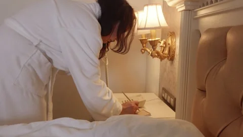 Woman making notes while using landline phone, multitasking Video stock 329237896