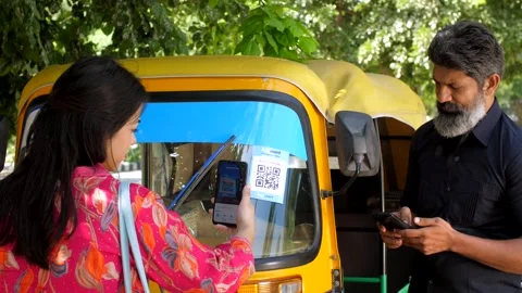 A woman making an online payment using online payment app - payment bar code,... Stock-Footage 258649304