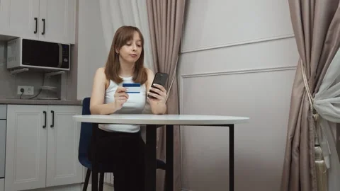 Woman making online payment using credit card and smartphone Stock Footage 313295206