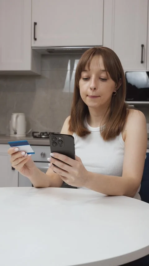Woman making online payment using credit card and smartphone Stock Footage 313295229