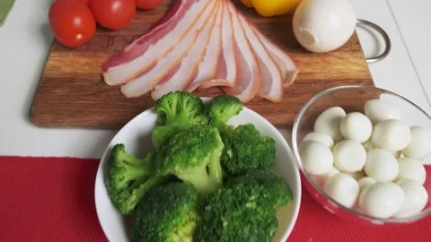 Woman making the salad with sliced bacon and vegetables Stock Footage 131784853