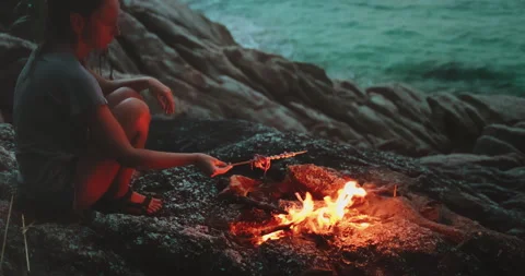 Woman making seafood barbeque on rocks sea cost Stock Footage 255518341