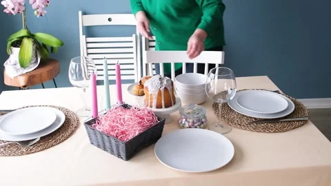 Woman making a table setting for Easter dinner Stock Footage 303640879