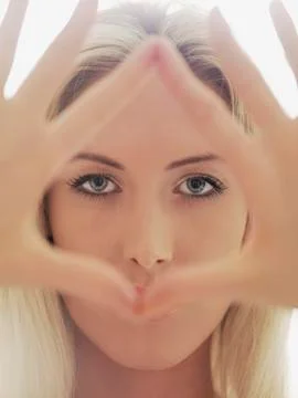 A woman making a triangular shape with her fingers Stock Photos