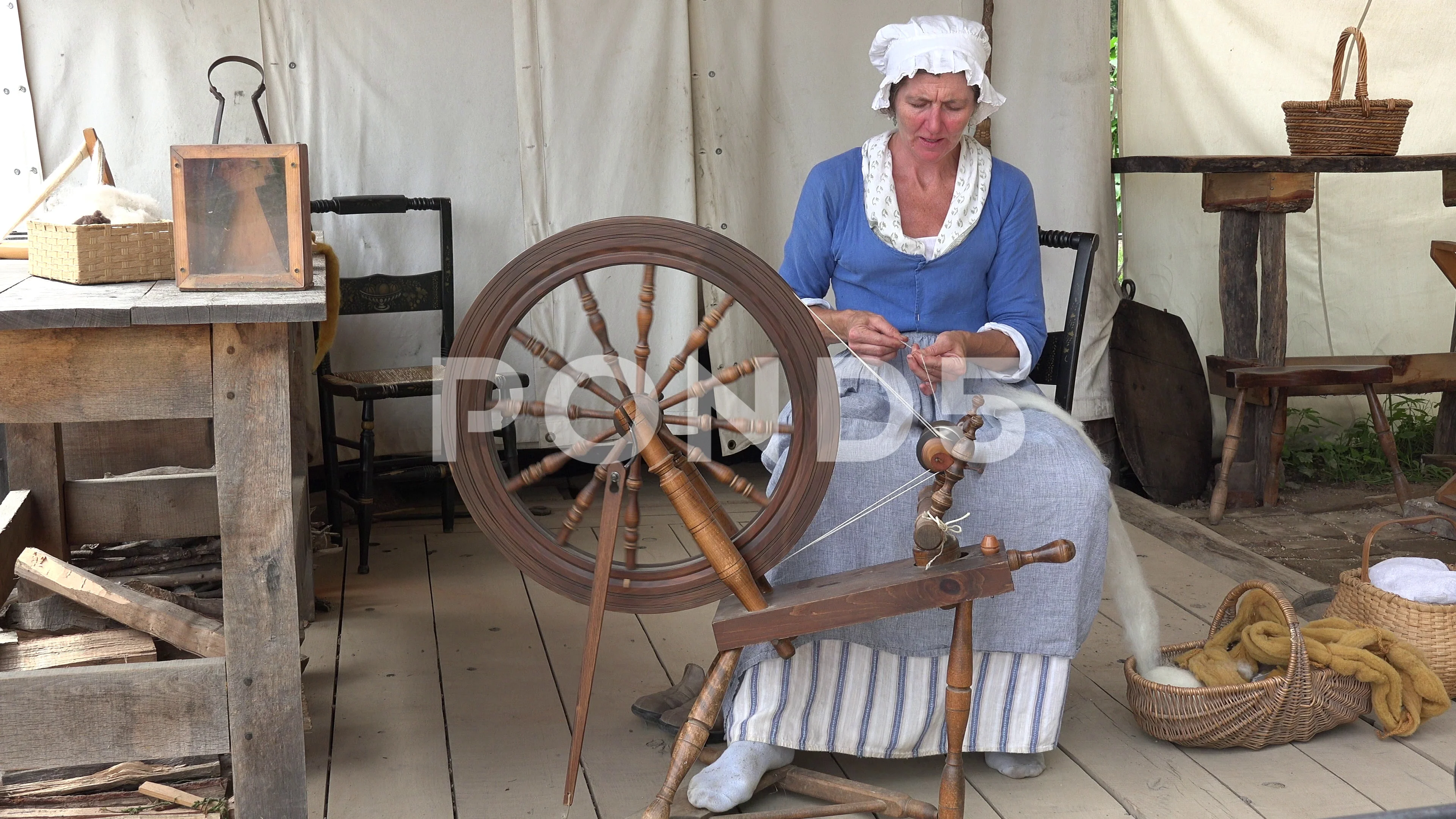 Spinners and weaver working on spinning wheels making yarn at the Shetland  Wool Week Stock Photo - Alamy