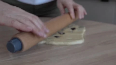Woman making yeast dough for easter baking. raisins, flour, butter. flowers in Stock Footage 307414383