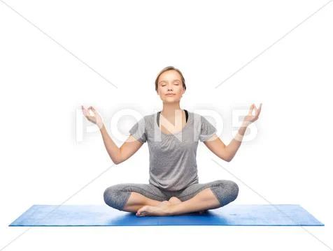 Woman making yoga meditation in lotus pose on mat Stock Photos