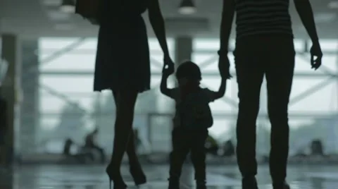 Woman man and child at the airport silhouettes Stock Footage