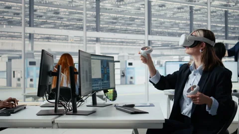 Woman in manufacturing lab using VR goggles to design semiconductors Stock Footage 335880437