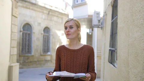 A woman with a map goes through the old town Stock Footage 101839472