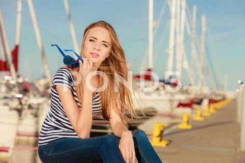 Woman in marina against yachts in port Stock Photos