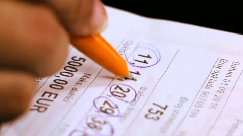 Woman marking numbers on the bingo ticket close up Stock Footage