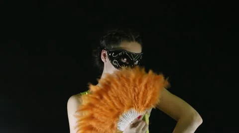 Woman in the mask with Fan Stock Footage