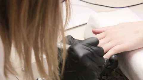 Woman master manicure draws a pattern on the nails. Stock Footage 131027246