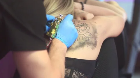 Woman master tattoo on back Stock Footage 79481949