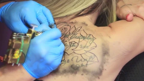 Woman master tattoo on back Stock Footage