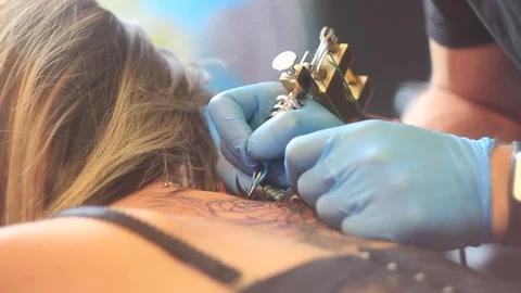Woman master tattoo on back Stock Footage 80592944
