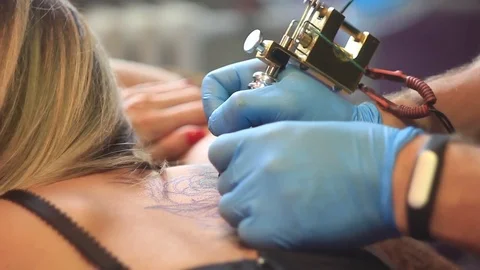 Woman master tattoo on back Stock Footage 80593133