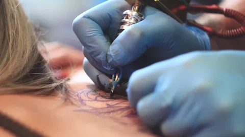 Woman master tattoo on back Stock Footage 80593196
