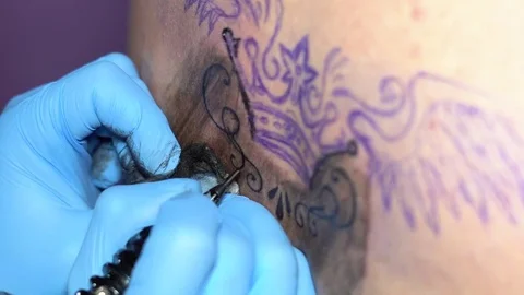 Woman master tattoo on back Stock Footage 84045214