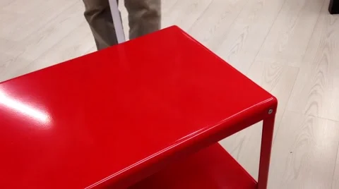 Woman measuring the red table size at Ikea store Stock Footage 54937210