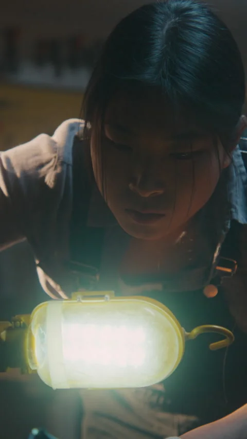 Woman Mechanic Inspecting Engine with Work Light Stock Footage 330264914