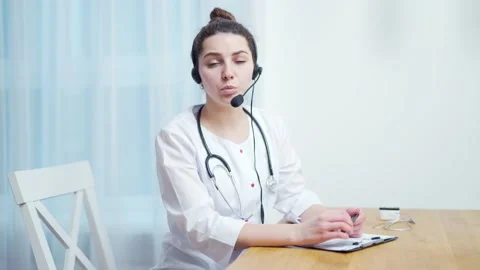 Woman medic worker video calling consulting patient online. Webcam view. Female  Stock Footage 145241983