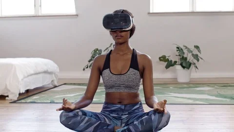 Woman meditating at home with VR goggles Stock Footage