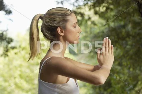 Woman Meditating In Park Stock Photos