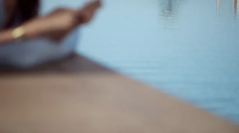 Woman messaging on mobile at poolside. Stock Footage 64113963