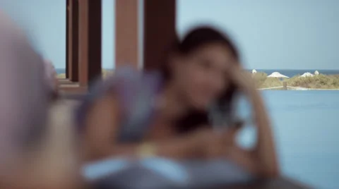 Woman messaging on mobile at poolside. Stock Footage 64113971