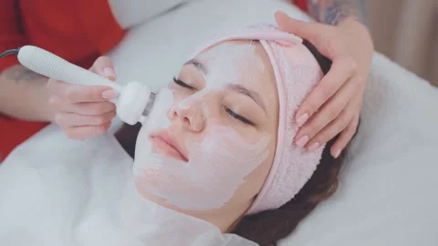 Woman on microcurrent face lifting therapy procedure in cosmetology clinic. Stock Footage 265111823