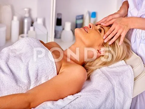 Woman middle-aged take face cleaning in spa salon. Stock Photos
