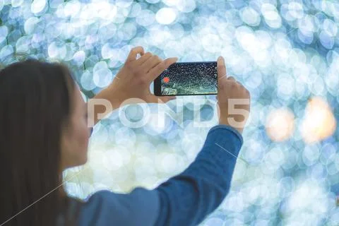 The woman with mobile camera shot bright lights Stock Photos