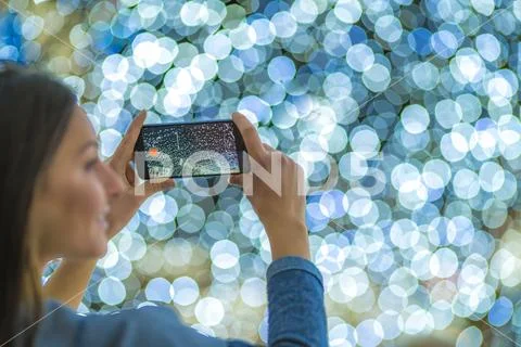 The woman with mobile camera shot bright lights Stock Photos