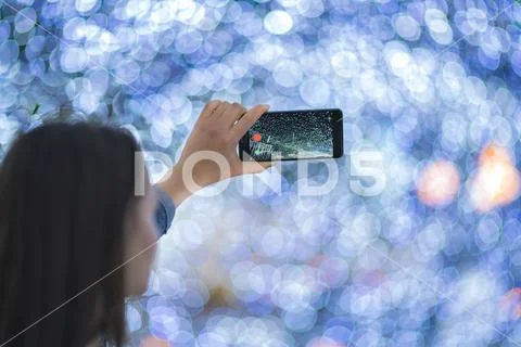 The woman with mobile camera shot bright lights Stock Photos