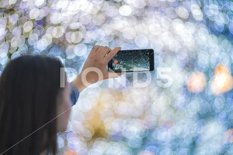 The woman with mobile camera shot bright lights Stock Photos