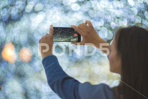 The woman with mobile camera shot bright lights Stock Photos